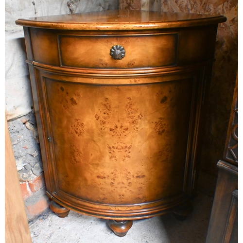 121 - A burr walnut veneer corner cabinet with single drawer over panelled cupboard and bun feet, 82 cm hi... 