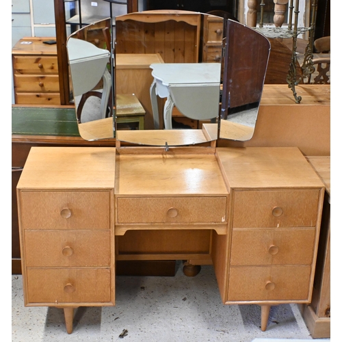 122 - A 'Meredew' light oak mirror backed dressing table with seven drawers and turned legs, 122 x 50 x 14... 