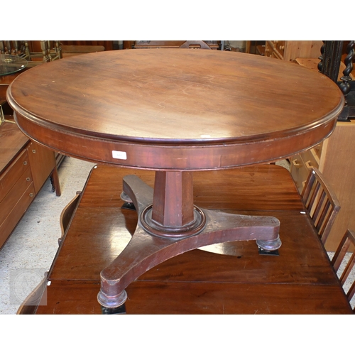 123 - A mahogany tilt top circular breakfast table on octagonal column and concave platform base, 118 cm d... 