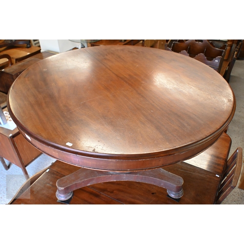 123 - A mahogany tilt top circular breakfast table on octagonal column and concave platform base, 118 cm d... 