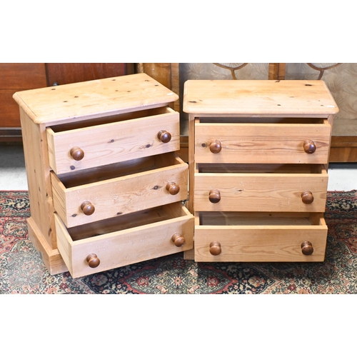 139 - A pair of small pine three drawer chests with turned handles, 54 x 30 x 62 cm high (2)