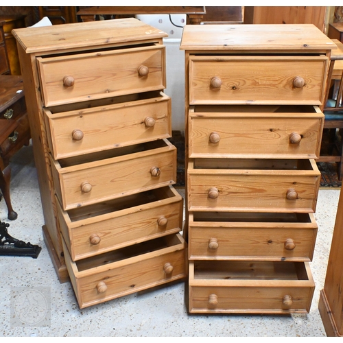 145 - A pair of pine five drawer tall boy chests with turned handles, 60 x 42 x 120 cm high to/w pine open... 