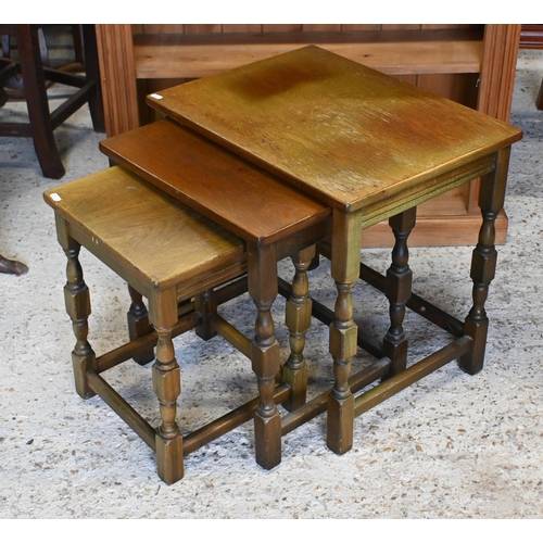 152 - A nest of three oak side tables on turned supports with stretchers, the largest 52 x 40 x 50 cm high