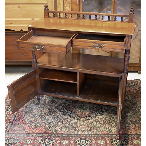 153 - An Edwardian mahogany buffet with two drawers and panelled cupboard doors on turned legs and casters... 