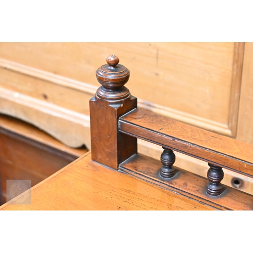 153 - An Edwardian mahogany buffet with two drawers and panelled cupboard doors on turned legs and casters... 