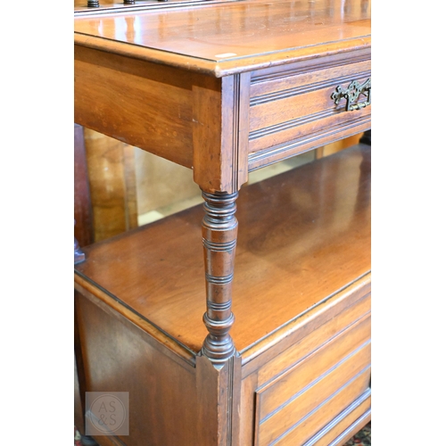 153 - An Edwardian mahogany buffet with two drawers and panelled cupboard doors on turned legs and casters... 