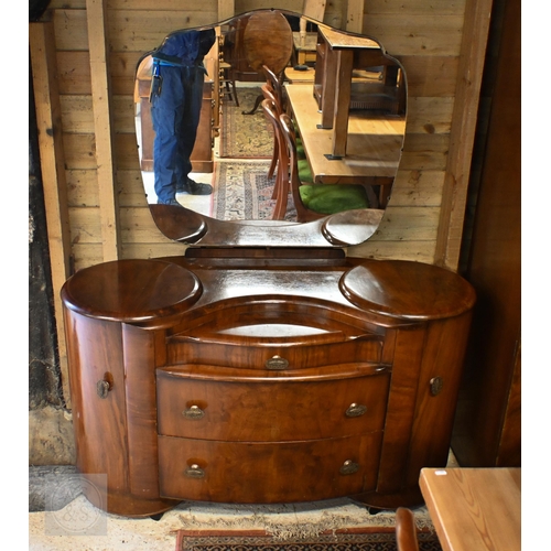 155 - A Shrager Art Deco walnut veneer dressing chest with cloud-shaped mirror over an arrangement of draw... 