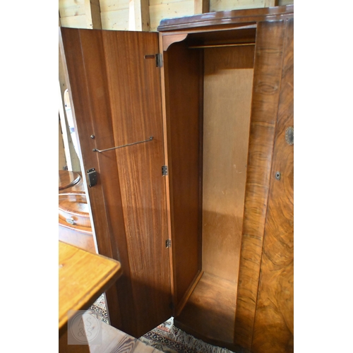 155 - A Shrager Art Deco walnut veneer dressing chest with cloud-shaped mirror over an arrangement of draw... 