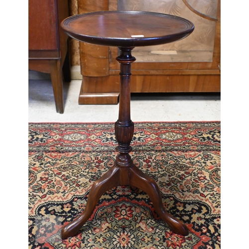 159 - A reproduction mahogany wine table on turned column and triform supports, 50 cm high