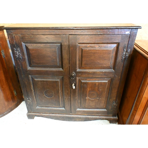 167 - An antique oak pantry cupboard with panelled doors enclosing fixed shelves, 110 x 30 x 108 cm high