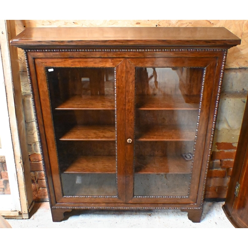 170 - A 19th century rosewood bobbin-moulded bookcase with glazed doors enclosing three shelves, standing ... 