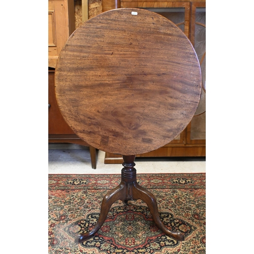 175 - A 19th century mahogany tilt-top table on turned column and triform supports, 64 cm diam x 70 cm hig... 