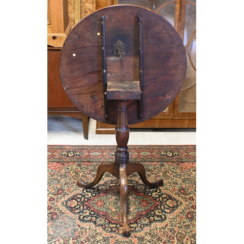 175 - A 19th century mahogany tilt-top table on turned column and triform supports, 64 cm diam x 70 cm hig... 