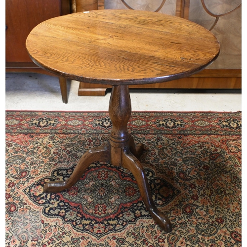 175 - A 19th century mahogany tilt-top table on turned column and triform supports, 64 cm diam x 70 cm hig... 