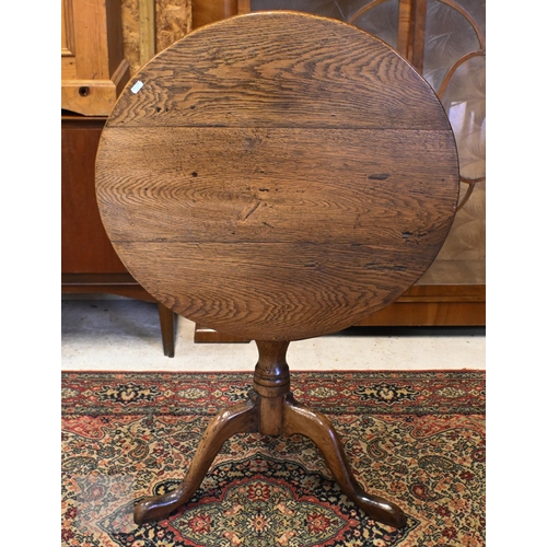 175 - A 19th century mahogany tilt-top table on turned column and triform supports, 64 cm diam x 70 cm hig... 