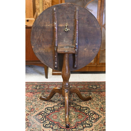 175 - A 19th century mahogany tilt-top table on turned column and triform supports, 64 cm diam x 70 cm hig... 