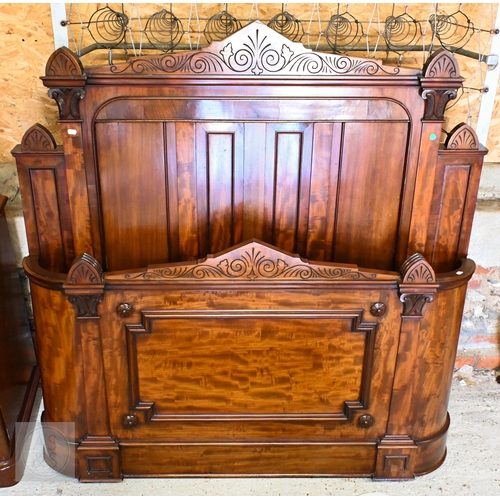 194 - A 19th century mahogany double bed with panelled headboard and curved footboard, scroll carved rails... 