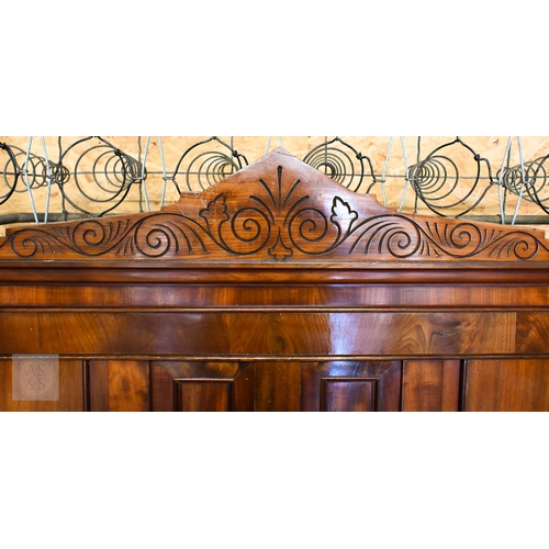 194 - A 19th century mahogany double bed with panelled headboard and curved footboard, scroll carved rails... 