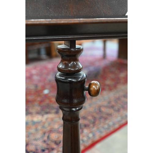 197 - An adjustable mahogany music stand with turned column and triform supports