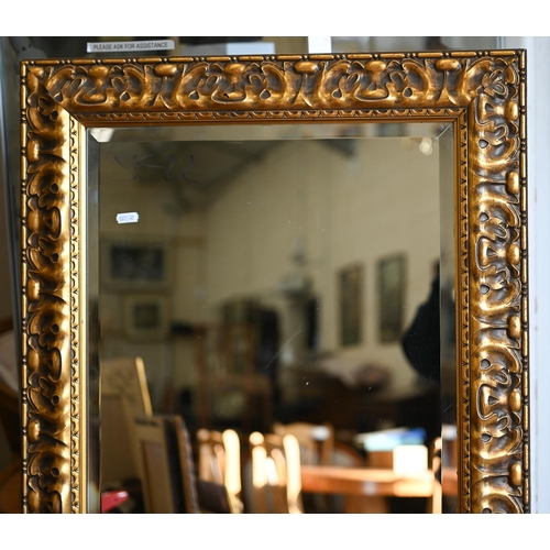 201 - Four graduating wall mirrors with moulded foliate gilt frames, two with bevelled plate and one havin... 