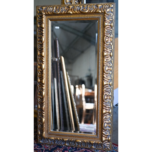 201 - Four graduating wall mirrors with moulded foliate gilt frames, two with bevelled plate and one havin... 