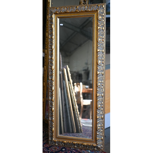 201 - Four graduating wall mirrors with moulded foliate gilt frames, two with bevelled plate and one havin... 