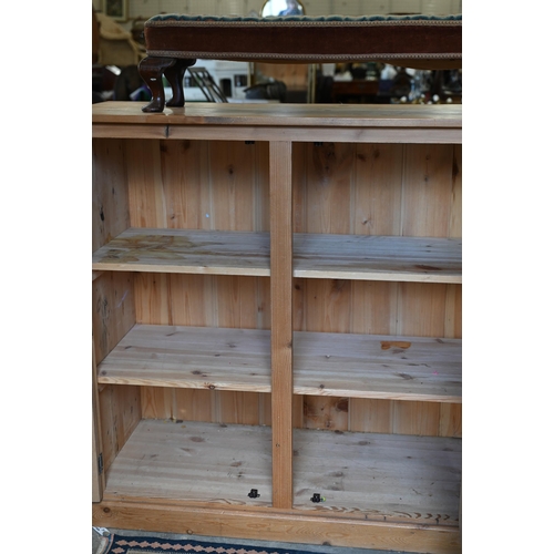 203 - A vintage stained pine pantry cupboard with two pairs of panelled cupboard doors enclosing shelved i... 