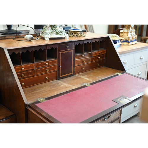 214 - A George III oak fall front bureau with fitted interior over four long graduated drawers, 106 x 50 x... 