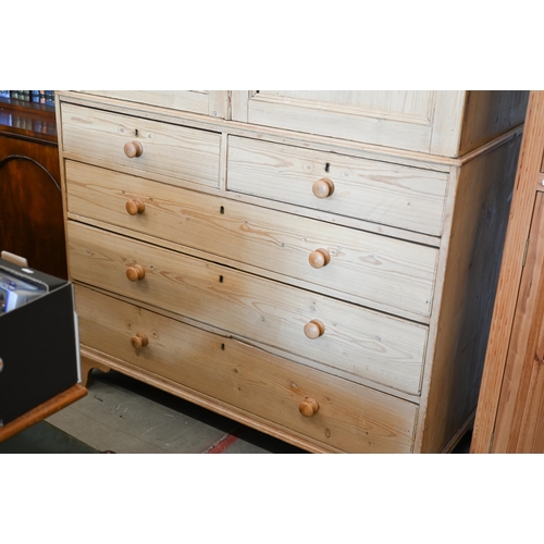 217 - Antique stripped pine linen press with dentil moulded cornice over twin panelled doors enclosing sli... 