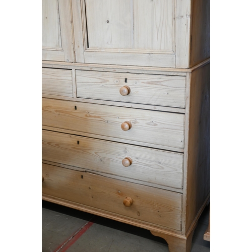 217 - Antique stripped pine linen press with dentil moulded cornice over twin panelled doors enclosing sli... 