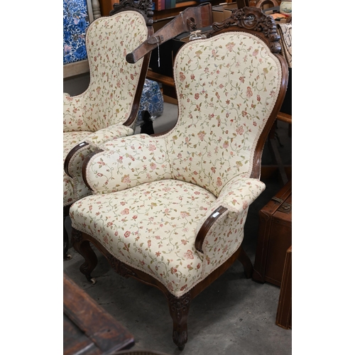 221 - A pair of Victorian floral carved mahogany armchairs upholstered in scrolling floral fabric