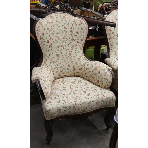 221 - A pair of Victorian floral carved mahogany armchairs upholstered in scrolling floral fabric