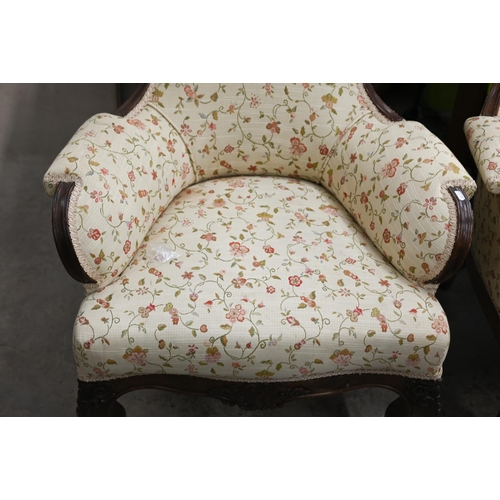 221 - A pair of Victorian floral carved mahogany armchairs upholstered in scrolling floral fabric