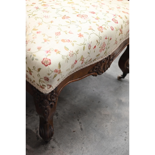 221 - A pair of Victorian floral carved mahogany armchairs upholstered in scrolling floral fabric