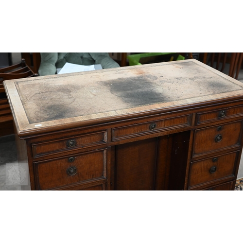 226 - Antique mahogany kneehole desk with tooled leather top (worn) over central recessed cupboard surroun... 