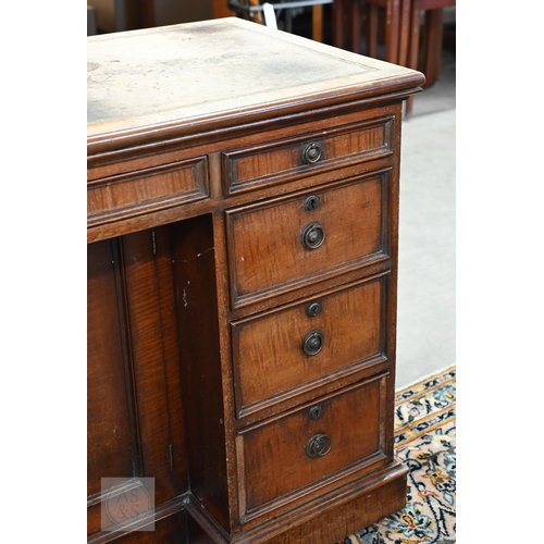 226 - Antique mahogany kneehole desk with tooled leather top (worn) over central recessed cupboard surroun... 