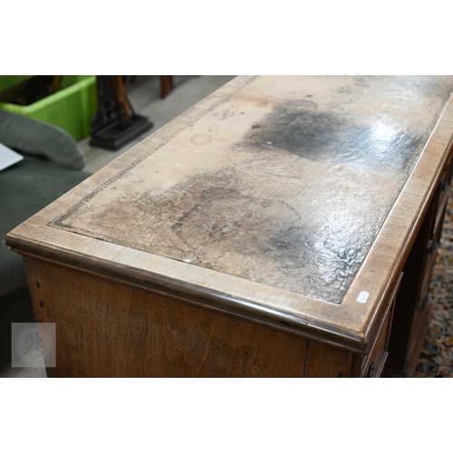 226 - Antique mahogany kneehole desk with tooled leather top (worn) over central recessed cupboard surroun... 