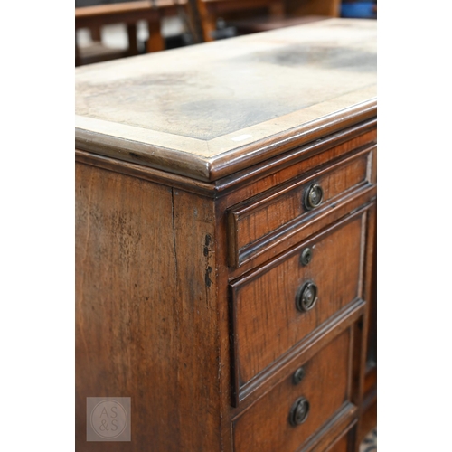 226 - Antique mahogany kneehole desk with tooled leather top (worn) over central recessed cupboard surroun... 