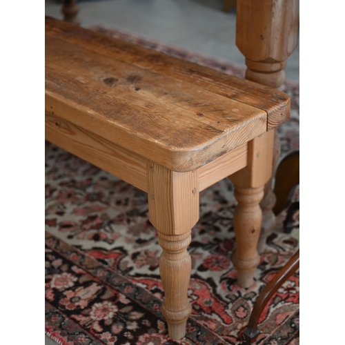 235 - A rustic stained pine bench on turned supports, 184 x 30 x 46 cm h