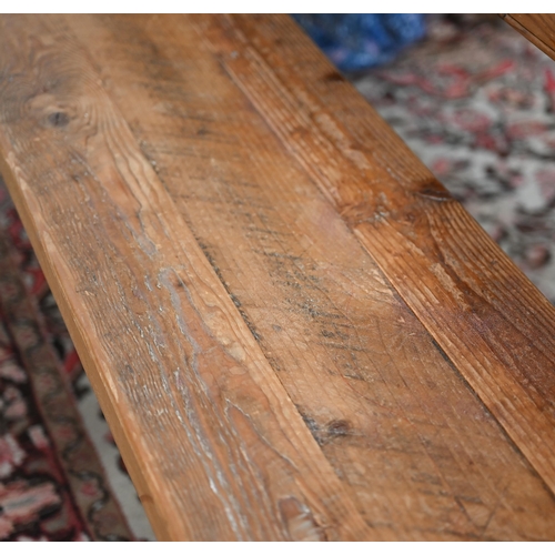 235 - A rustic stained pine bench on turned supports, 184 x 30 x 46 cm h