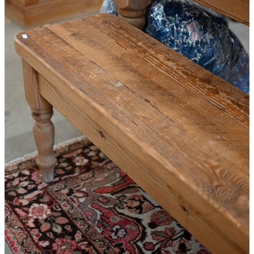 235 - A rustic stained pine bench on turned supports, 184 x 30 x 46 cm h