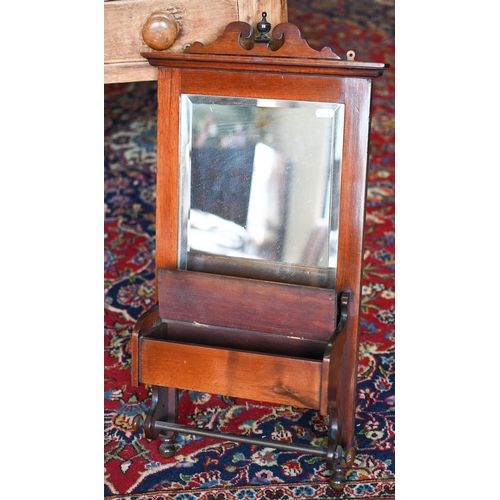 238 - An antique mahogany framed shaving mirror with bevelled glass, vanity box and brass towel rail, 70 x... 