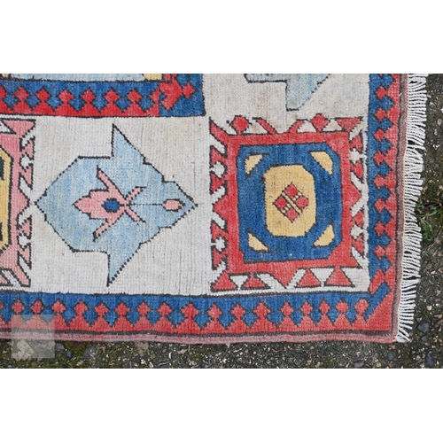 250 - Vintage Turkish carpet, bold geometric design on blue/red ground, with ivory border, 285 x 200