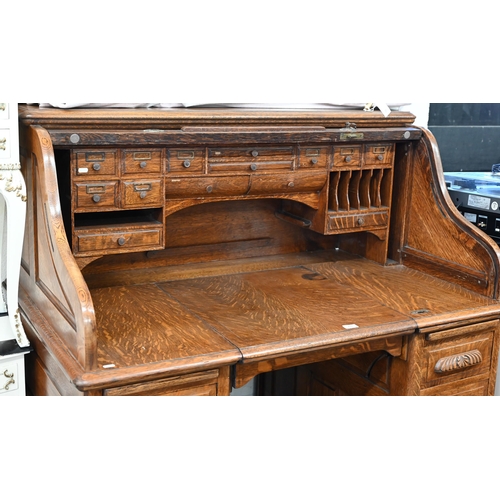 255 - Early 20th century large oak roll-top desk with drawer slide enclosing fitted interior over eight dr... 