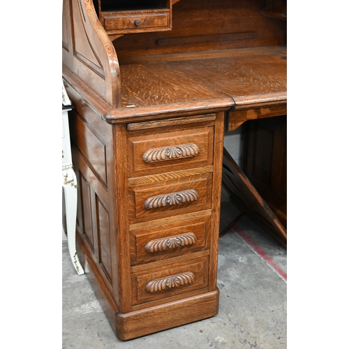 255 - Early 20th century large oak roll-top desk with drawer slide enclosing fitted interior over eight dr... 