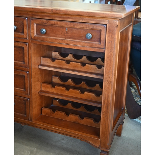 257 - A 'Stanley Furniture' cherrywood sideboard with six drawers around open wine rack shelves (24 bottle... 