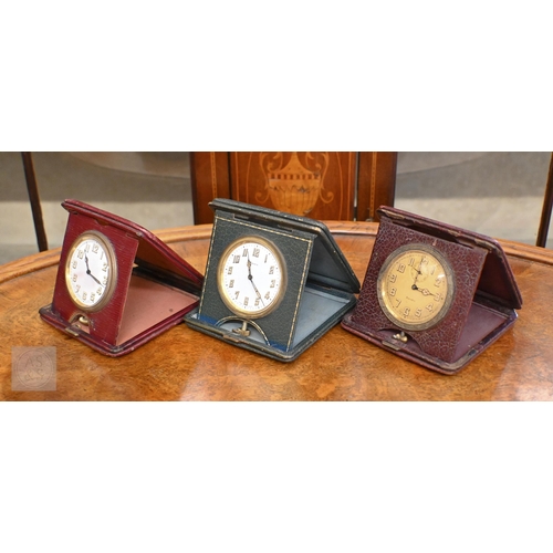 266 - A trio of vintage leather cased travel clocks, 8-day Swiss movements to/with three miniature travel ... 