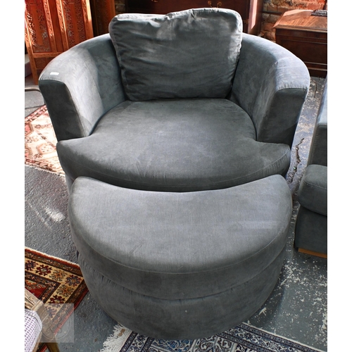 269 - A large circular revolving loveseat armchair and matching crescent form stool, in grey fabric by DFS... 