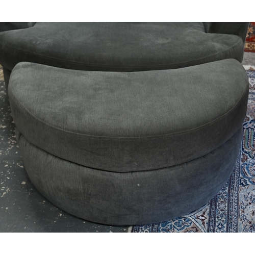 269 - A large circular revolving loveseat armchair and matching crescent form stool, in grey fabric by DFS... 