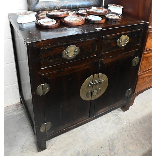 30 - An old Chinese stained hardwood and brass mounted cabinet, with two drawers over cupboard doors, 90 ... 